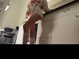 Amazingly beautiful petite blonde hot college girl in her dormitory kitchen getting ready for Christmas Party