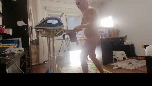 Sexy brunette doing naked chores around the house.