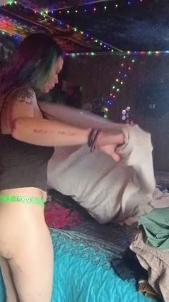 Folding Laundry In A Green Thong
