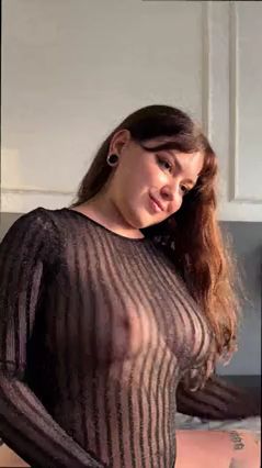 Curvy girl in sheer top teasing with her hips